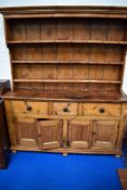 A 19th Century rustic pine dresser having three tier plate rack to back , three drawers and two