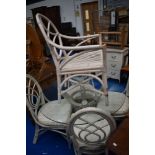 A bentwood and cane conservatory style dining suite comprising glass top table and five chairs