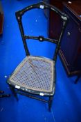 A Victorian Aesthetic ebonised bedroom chair having mother of pearl inlay