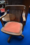 An early 20th Century oak swivel office chair