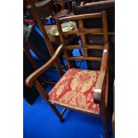 An early 20th Century oak carver chair having scroll arm and back lozenge design