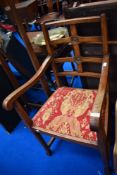 An early 20th Century oak carver chair having scroll arm and back lozenge design