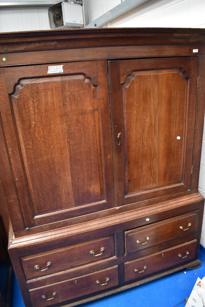 An 18th Century oak linen press having four drawers to base, width 145cm