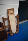 A vintage toy ironing board and clothes maid