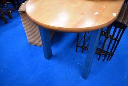 A modern beech topped oval kitchen table having welded stainless steel framed base/legs 150 x 72cm