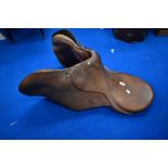 A vintage leather saddle, studs marked Gibson Saddlers, New Market