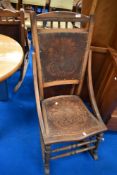 A 19th Century stained frame rocking chair having decorative ply seat and back