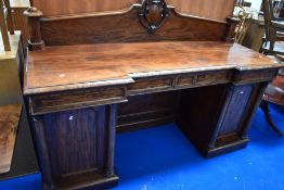 A 19th Century mahogany sideboard of large proportions having cartouche ledge back and breakfront