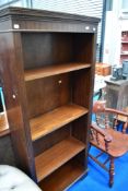 A modern mahogany narrow full height bookshelf