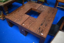 An interesting designer coffee table , with two parts coming together to form square with opening to