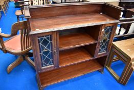 A 19th Century mahogany low bookcase having coloured leaded glass sections to the sides of the