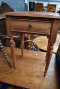 A reproduction mahogany occasional table in the Victorian style having frieze drawer and turned