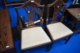 A pair of 19th Century dining chairs having splat backs and upholstered seats