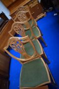 A set of four reproduction Hepplewhite style shield back dining chairs