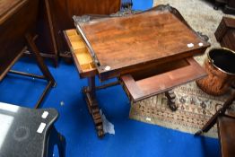 A 19th Century mahogany sewing table having pull out fabric section and end drawer , with foliate