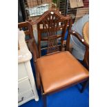 A reproduction mahogany carver chair with mismatched drop in seat
