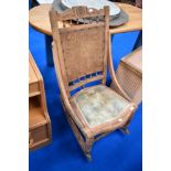 A 19th Century rocking chair having stripped frame