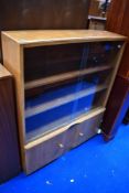 A golden oak bookcase with double cupboard under