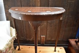 A reproduction demi lune side table