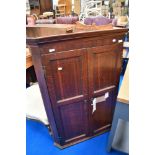 A George III oak wall corner cupboard