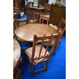 An Ercol colonial style extending dining table and set of four similar dining chairs