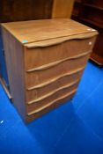 A teak effect laminate bedroom chest of four drawers