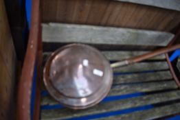 A traditional copper warming pan