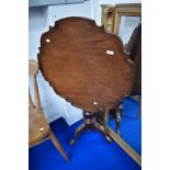 A 19th Century mahogany pedestal occasional table having shaped top , turned column and triple splay