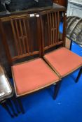 A pair of early 20th mahogany rail back dining chairs