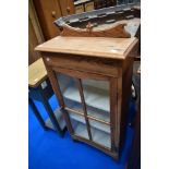 An early 20th Century oak bookcase/display cabinet of small proportions