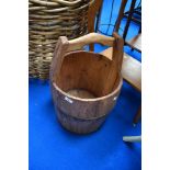 A vintage wooden milk pail