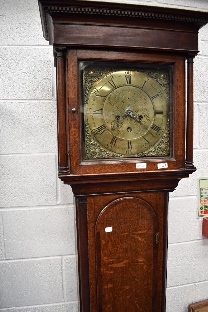 An 18th Century oak long cased clock having 8 day movement with brass dial , marked I,LL