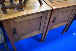 A pair of Arts and Crafts golden oak bedside cabinets