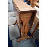 An Arts and Crafts style golden oak occasional gateleg table, width approx. 61cm