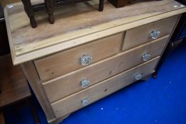 A Victorian stripped pine chest of two over two drawers, having glass handles