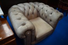 A modern leather chesterfield style armchair in grey, some light scuffing