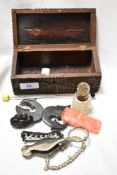 A carved hardwood money box containing costume jewellery brooches, magnifying glass, manicure set,