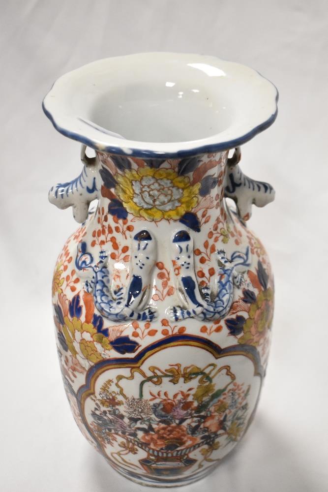 A 20th Century Chinese vase, decorated in Imari colours, having a flared rim, and six figure - Image 2 of 3