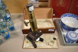An early 20th century 'Improved Household Microscope' having rack and pinion focus from the right