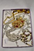 A box of costume jewellery, to include gold coloured chains and others