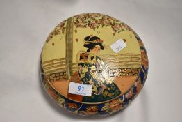 A modern Japanese Satsuma porcelain lidded bowl, decorated with Geisha and floral designs,