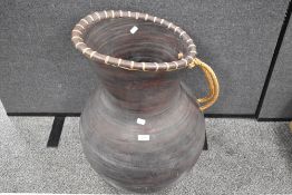 An oversized terracotta jug, approx 27' height.