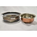 A Cavalier silver plated bottle coaster and an Eastern copper and white metal footed bowl