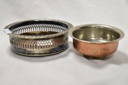 A Cavalier silver plated bottle coaster and an Eastern copper and white metal footed bowl