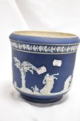 An Adams blue Jasper ware jardiniere, sprigged with classical figures within a landscape and below a