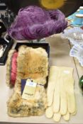 A pair of vintage suede gloves, a 1960s purple feathered hat and an as new faux fur scarf, having