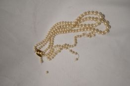 A string of synthetic pearls with 9ct gold clasp