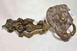 A vintage cast-brass lion mask form door knocker, sold along with a cast-brass door knocker of