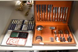 A vintage teak canteen of cutlery, a set of green handled butter knives in box and another box