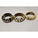 Three decorative Eastern bangles with white metal mounts